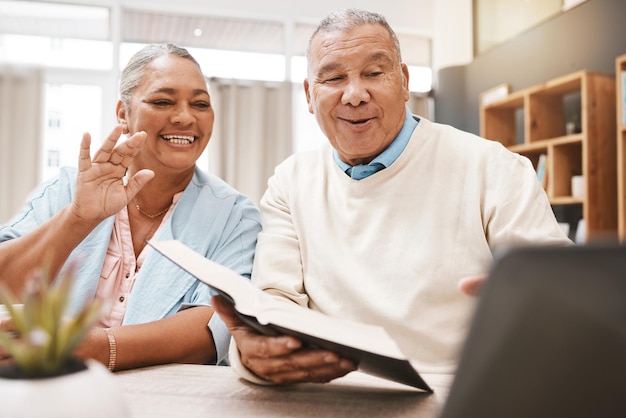 Vaguez un ordinateur portable et un couple de personnes âgées en appel vidéo avec un livre ou une bible pour l'étude spirituelle ou la lecture à la maison