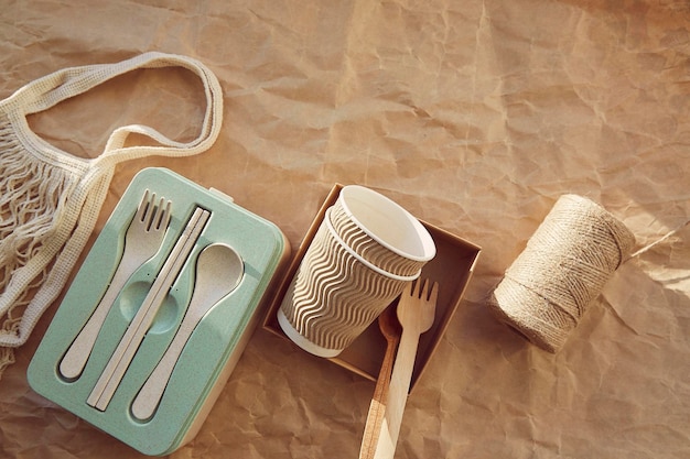 Vaisselle jetable écologique couverts gobelets en carton à partir de matériaux naturels avec sac réutilisable sur papier froissé Mode de vie durable zéro déchet