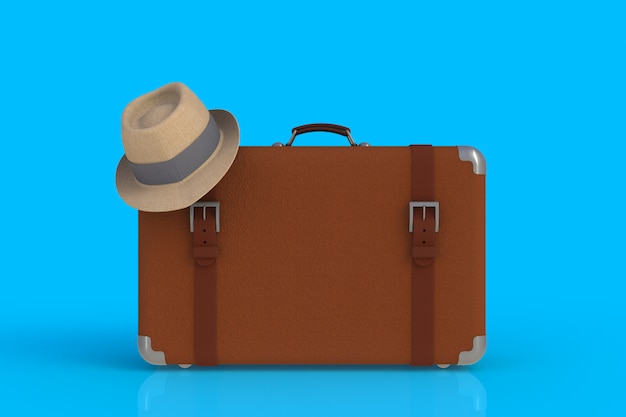 Valise d'un voyageur avec chapeau de paille