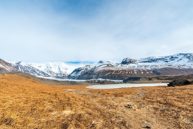 Vallées des montagnes lac gelé et pré près du glacier en Islande