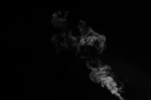 La vapeur de fumée dense de bouclage blanc qui monte est isolée sur fond noir pour superposer vos photos Fond de vapeur