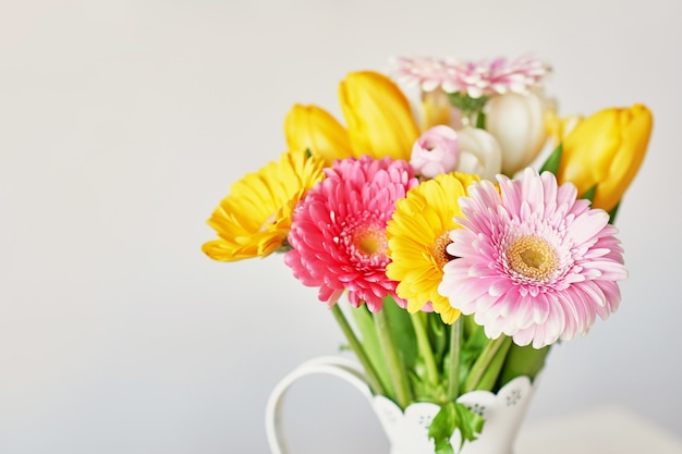 Vase avec bouquet de belles tulipes et gerberas