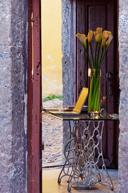 Vase et ordinateur portable sur le bureau dans un vieux bâtiment en pierre