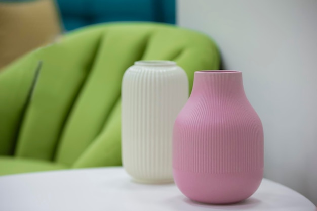 Un vase rose se dresse sur la table dans la chambre