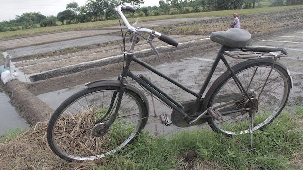 Photo un vélo est garé sur le bord de la route avec un panneau qui dit 