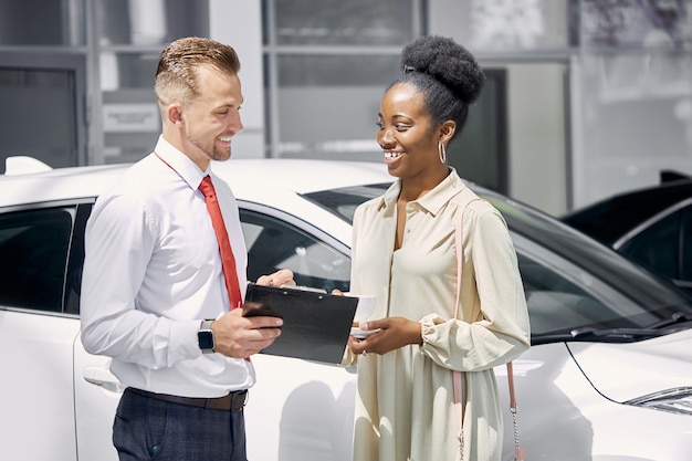 Photo un vendeur caucasien sympathique parle avec une femme cliente noire