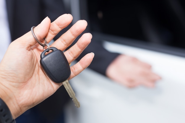 Vendeur de voitures remettant la clé