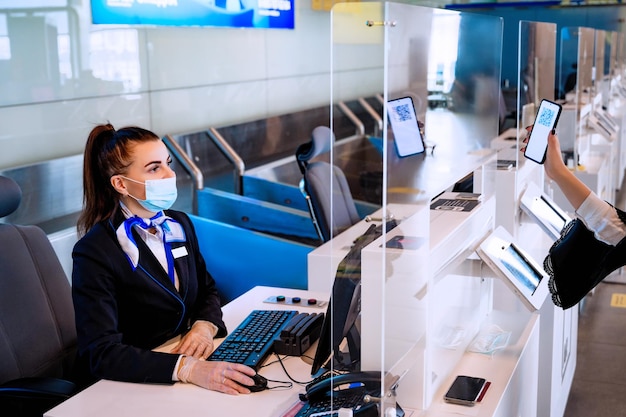 Vérification du passeport vaccinal par le personnel au sol au terminal de l'aéroport