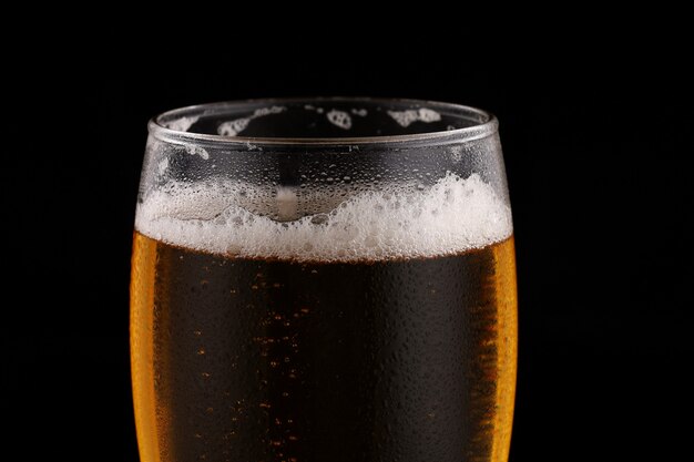 Verre de bière légère sur une surface sombre