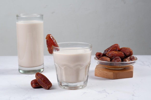 verre de lait de dattes (susu kurma ) sur fond blanc