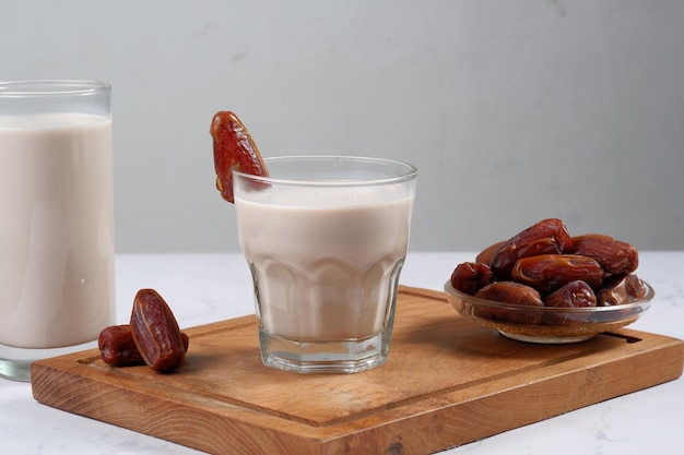 verre de lait de dattes (susu kurma ) sur fond blanc