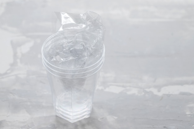 Verre en plastique avec du plastique sur fond en céramique