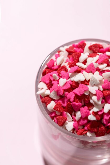 Verre de Saint Valentin avec beaucoup de coeurs de bonbons sucrés