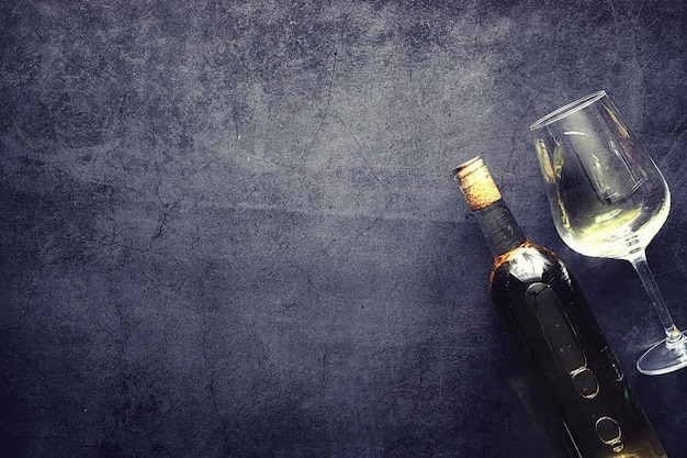 Un verre de vin rouge sec sur la table. Bouteille sombre et verre de vin.