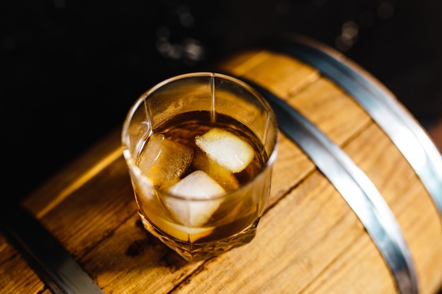 Un verre de whisky assis sur un tonneau en bois