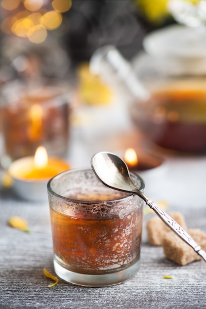 Verres avec des bougies allumées et théière