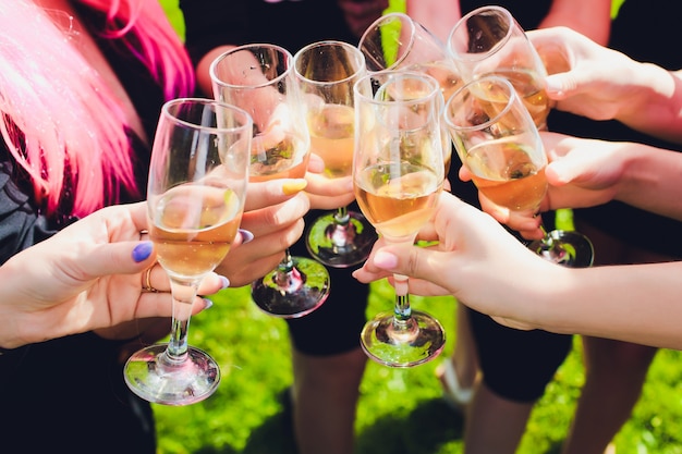 Verres tintants avec alcool et grillage, fête. Félicitations à l'événement. Amis de fête joyeux.