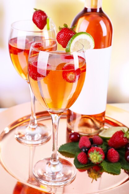 Photo verres de vin aux fraises et citron vert sur plateau métallique sur fond flou