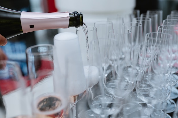 Verser le vin mousseux de la bouteille dans le verre de champagne