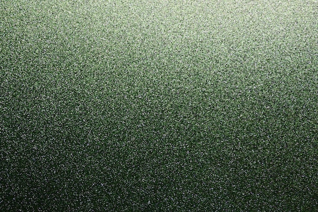 Vert herbeux profond Texture de papier ou de carton rugueux Bokeh défocalisé scintille et brille sur le pli Fond vert festif avec dégradé éclairé en haut à droite