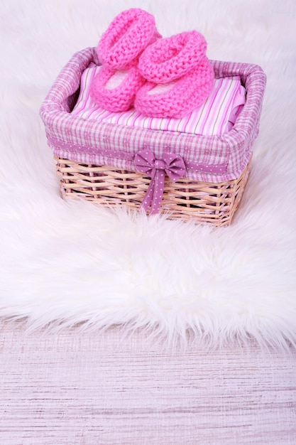 Vêtements de bébé dans le panier au sol dans la chambre