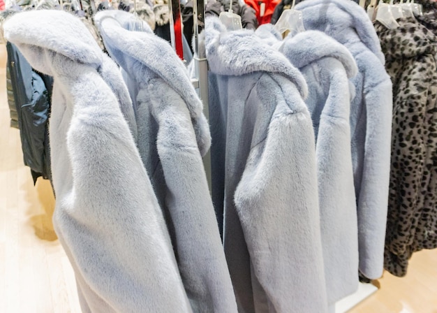 Photo des vêtements chauds accrochés à la vente au magasin