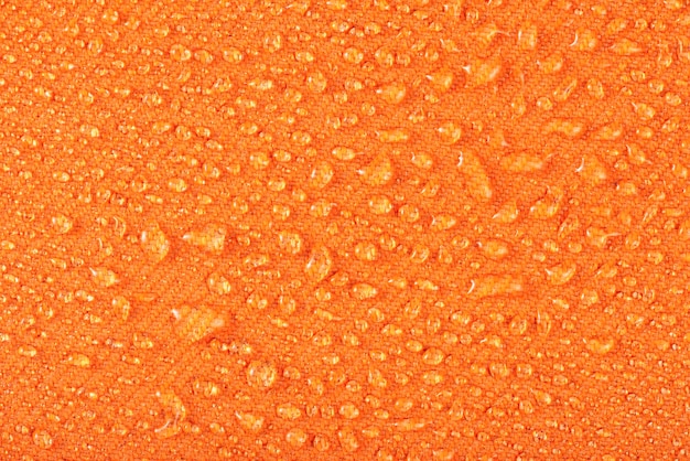 Vêtements imperméables ou meubles rembourrés fabriqués à partir de textiles imperméables gouttes d'eau sur orange