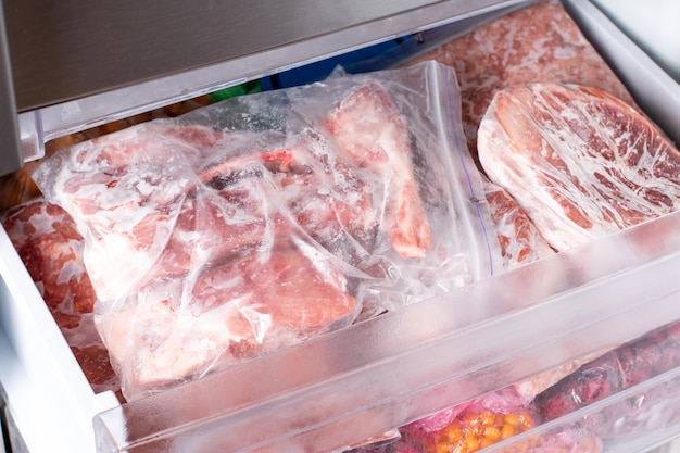 Viande congelée dans un emballage en plastique au congélateur. Des surgelés