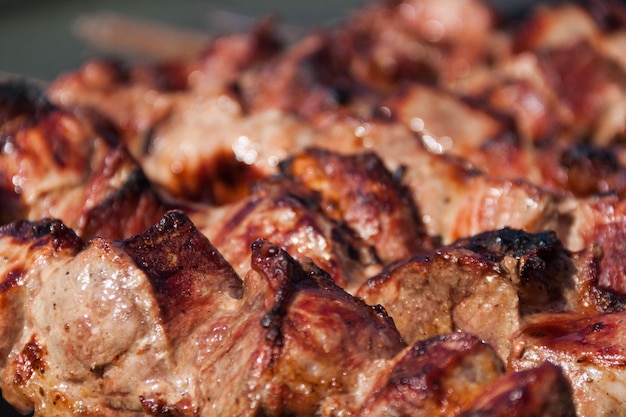 La viande est cuite sur une brochette sur une brochette Fond et texture de brochettes Viande délicieuse avec peau