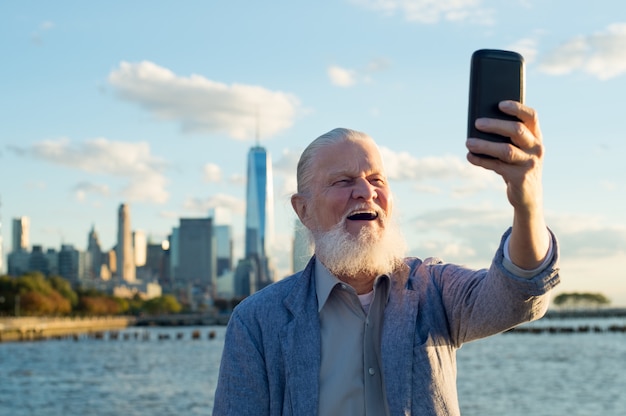 Vieil homme en bonne santé prenant selfie