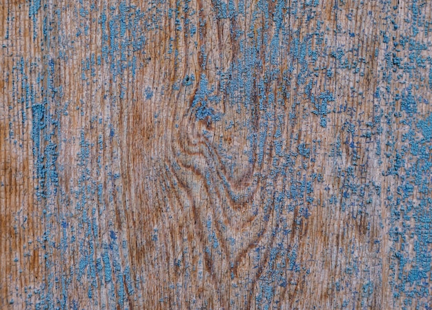 Une vieille porte en bois recouverte d'une vieille peinture bleue fissurée Surface rugueuse inégale Texture rugueuse Résumé fond