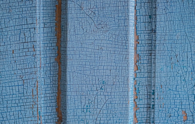 Photo une vieille porte en bois recouverte d'une vieille peinture bleue fissurée surface rugueuse inégale texture rugueuse résumé fond