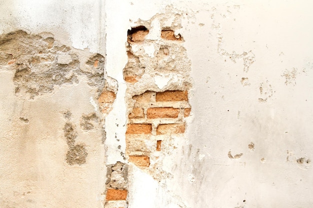 Photo vieux fond de mur de brique et de ciment fissuré