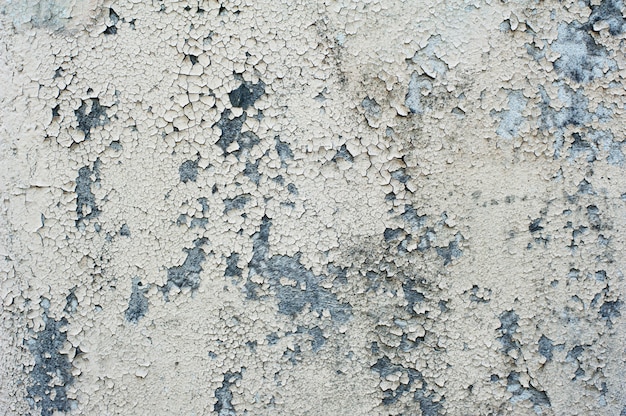 Vieux fond de texture de mur avec de la peinture blanche fissurée