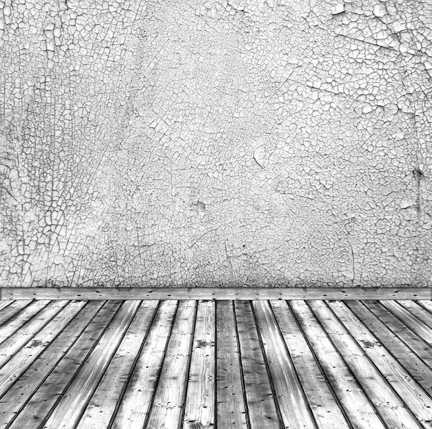 Vieux mur blanc fissuré et plancher en bois. fond intérieur rustique