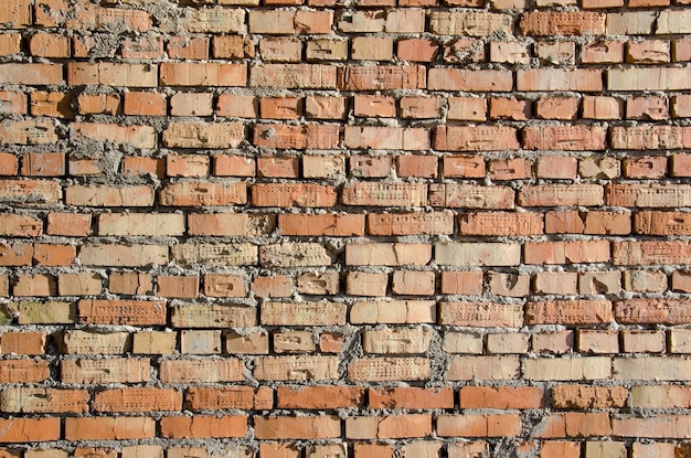 Vieux mur de briques ancienne texture de blocs de pierre rouge et orange Gros plan