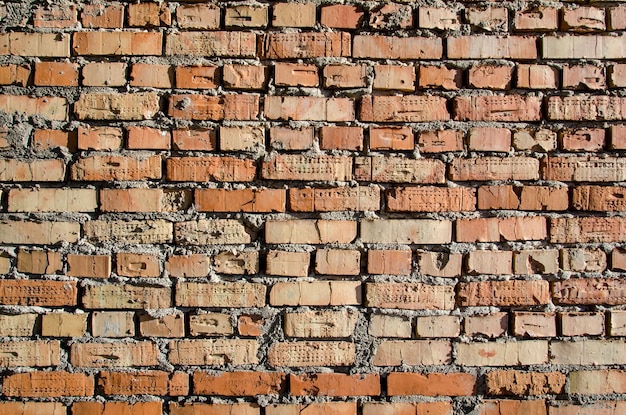 Vieux mur de briques ancienne texture de blocs de pierre rouge et orange Gros plan