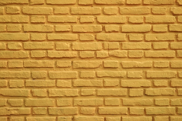 Vieux mur de briques de couleur jaune toscane
