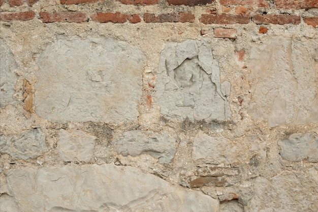 Vieux mur de briques gris détruit