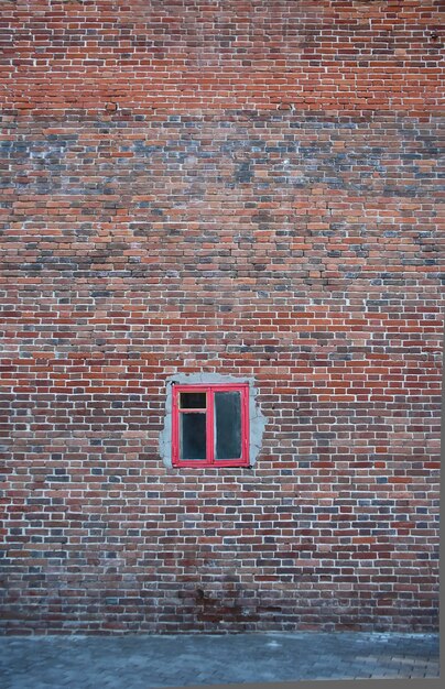 Vieux mur de briques grunge vintage et petite fenêtre