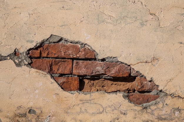 Vieux mur de briques et plâtre