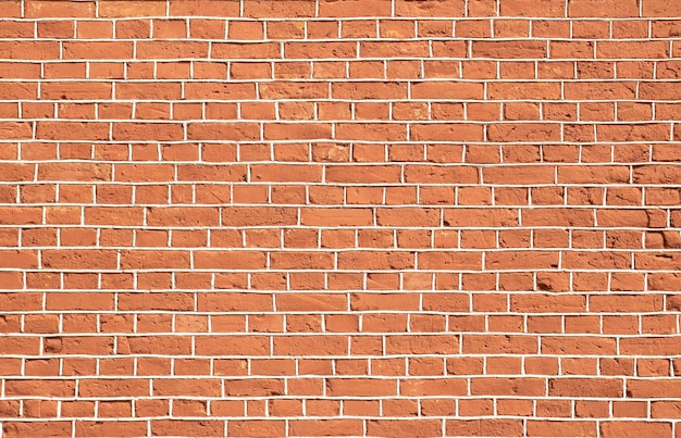 Vieux mur de briques rouges avec joints de ciment gris