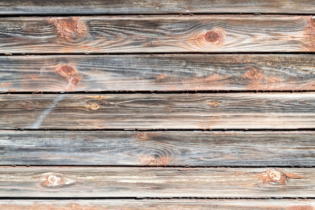 Vieux mur d'épluchage en bois avec des planches horizontales. Fond texturé.