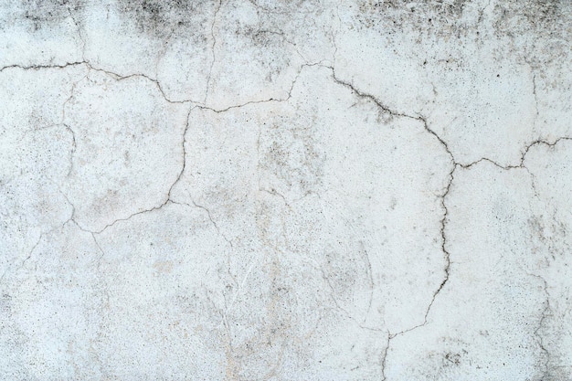 Vieux mur de pierre en béton recouvert de plâtre fissuré et de surface texturée grunge sale