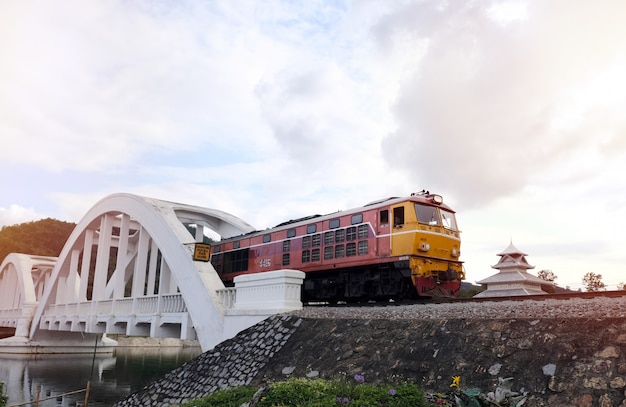 Photo vieux train diesel en cours d'exécution sur le pont sur le pont blanc le célèbre pont en acier à lampoon, thaïlande