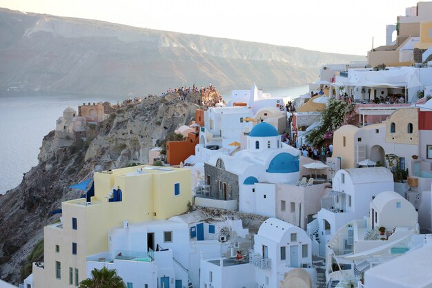 Village pittoresque d'Oia avec les touristes pour le spectacle du coucher du soleil, l'île de Santorin, Grèce