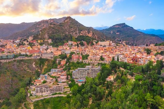 Ville sur les pentes des montagnes et des collines vue aérienne du paysage urbain du soir