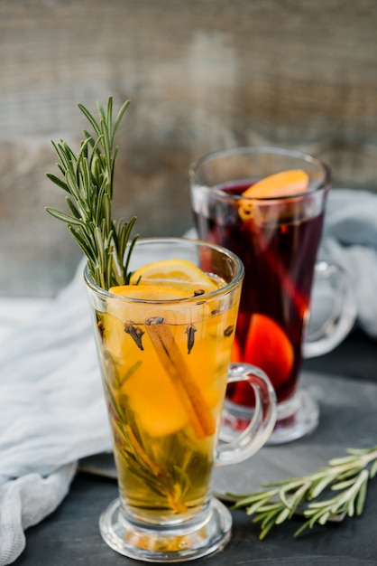 Vin chaud rouge et blanc avec des épices sur fond de pierre sombre