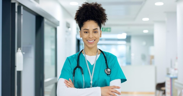 Photo visage de soins de santé et femme ou infirmière avec les bras croisés pour la santé, la confiance et le service à l'hôpital ou à la clinique portrait de personne ou de médecin heureux pour une carrière en cardiologie ou en soins infirmiers sur le lieu de travail