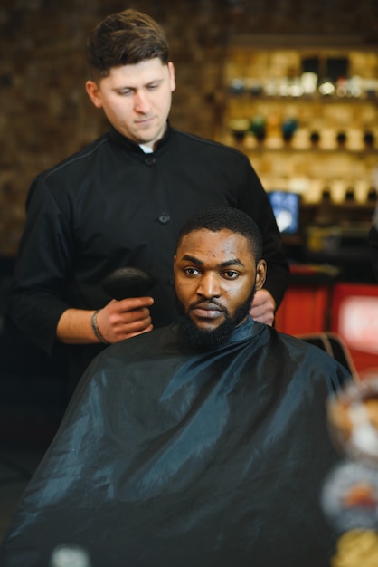 Visite de salon de coiffure homme afro-américain dans un salon de coiffure élégant